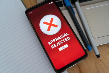 Appraisal rejected notification on smartphone. Concept of bad appraisal.