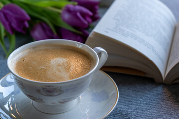 Relaxing and peaceful moment with a book and coffee. 
