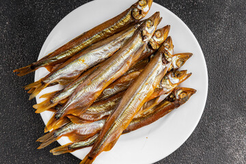 Smoked sprat fish capelin dish fresh gourmet food background on table rustic food top view copy...