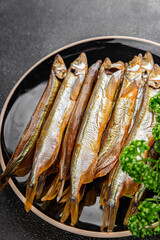 Smoked sprat fish capelin dish fresh gourmet food background on table rustic food top view copy space pescetarian diet