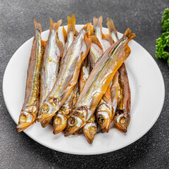 Smoked sprat fish capelin dish fresh gourmet food background on table rustic food top view copy space pescetarian diet
