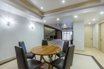 Modern interior with open space. Stylish dining room with an open conceptual view of the living room with an exclusive architectural design.