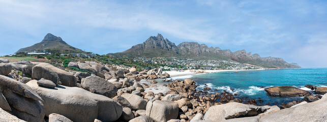 Cape Town, South Africa with Table mountain, Lions Head, Camps Bay and the 12 Apostles - Cinematic Breathtaking travel panorama with peaceful blue sky

