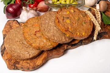 Round vegetarian patties or burgers made from grains, soybeans, vegetables and legumes