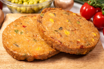 Round vegetarian patties or burgers made from grains, soybeans, vegetables and legumes