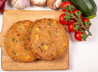 Round vegetarian patties or burgers made from grains, soybeans, vegetables and legumes