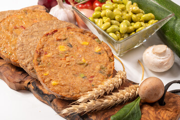 Round vegetarian patties or burgers made from grains, soybeans, vegetables and legumes