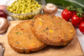 Round vegetarian patties or burgers made from grains, soybeans, vegetables and legumes