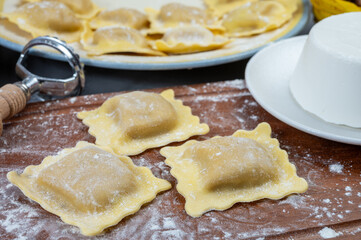 Italian food, fresh home made stuffed pasta ravioli dumplings with ricotta soft cheese and...