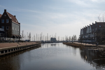 Tourists destination in North Holland, old authentic fishermen village Volendam near Amsterdam with old houses and narrow streets