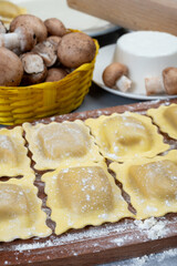 Italian food, fresh home made stuffed pasta ravioli dumplings with ricotta soft cheese and champignons porcini mushrooms, Parma, Emilia Romagna, Italy