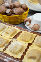 Italian food, fresh home made stuffed pasta ravioli dumplings with ricotta soft cheese and champignons porcini mushrooms, Parma, Emilia Romagna, Italy