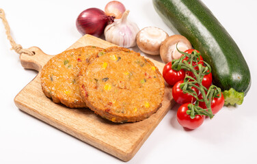 Round vegetarian patties or burgers made from grains, soybeans, vegetables and legumes