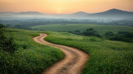 Obraz premium Serene Sunrise Over Rolling Hills and Winding Country Road