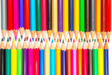 A rainbow of colored pencils stacked in a grid formation on a white background. Perfect for promoting creativity, school essentials, or art-related content.