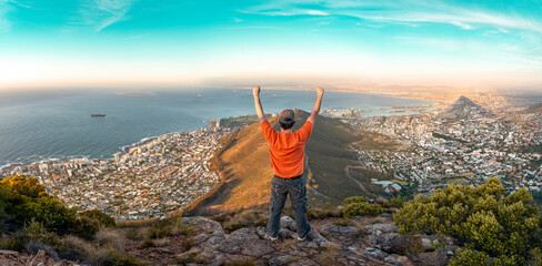 Top of the world - Victory and success. Cape Town hiker reaches summit of Lions Head, Table Mountain. South Africa is best travel and tourism destination for adventure and nature