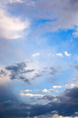 Stunning cloudy sky at dusk with beams of golden sunlight piercing through. The dramatic contrast of light and shadow offers a captivating backdrop for nature, mood, and inspirational photography.