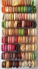 a box of doughnuts and pastries of different colors 