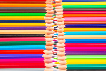 Sharpened multicolored pencils in a grid pattern. Suitable for art supplies, educational materials, or creative stationery imagery.