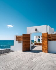 White-walled entrance gate with wooden accents against a blue sky and sea in Archdaily style