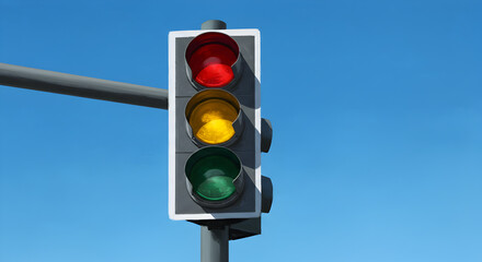 Traffic Signal with Red Yellow and Green Lights against a Bright Blue Sky Daytime Road Safety Device