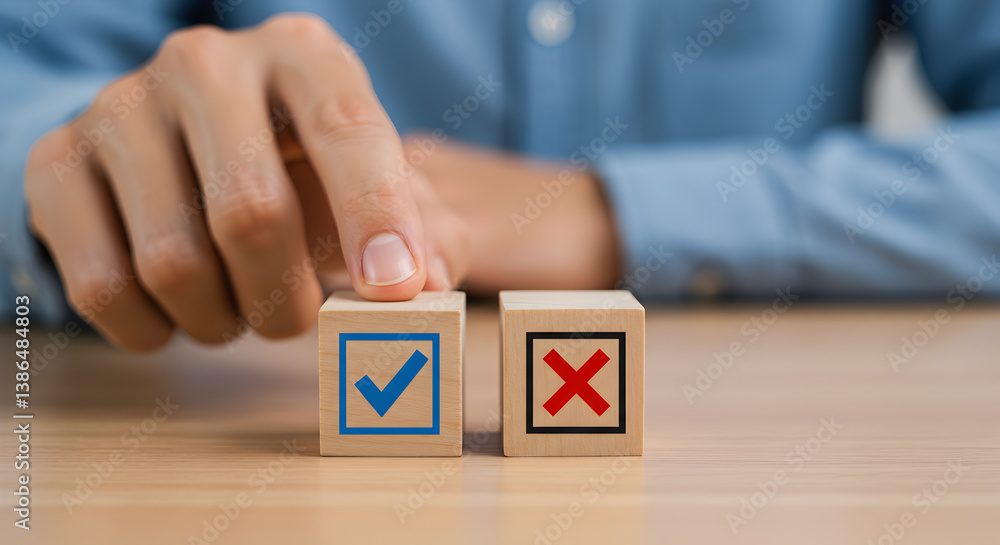 Poster hand selecting decision on wooden block with blue tick and red cross on wooden table in soft lightin