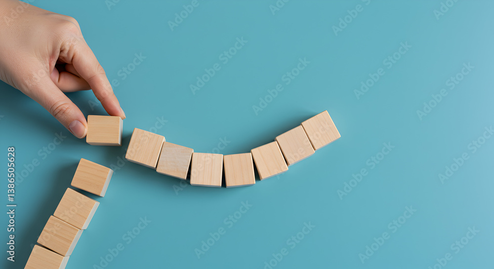 Poster hand arranging wooden blocks in a curved shape on turquoise background featuring minimalist design a