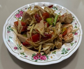 Spicy papaya salad with shrimp and fermented fish