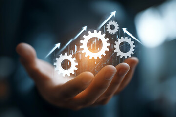 A hand holds gears and arrows, symbolizing progress, innovation, and growth in technology or business.