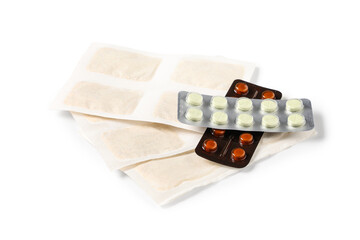 Mustard plasters with pills on white background