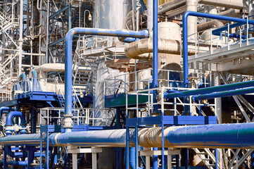 Detailed view of a chemical plant showcasing intricate piping systems and industrial infrastructure...