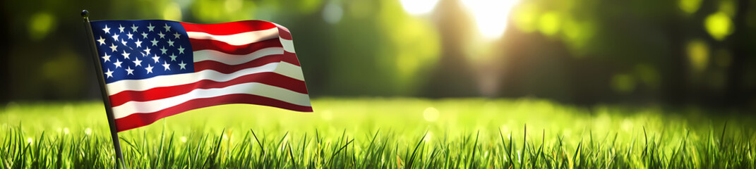 Fototapeta premium American Flag on Green Field: The American flag flutters proudly against a backdrop of lush green grass and a sun-drenched forest. The scene evokes a sense of patriotism, freedom, and natural beauty.