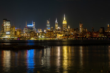 Fototapeta premium New York City at night. NYC cityscape with skyscrapers. Panoramic of New York City skyline on dusk. Manhattan skyline. New York and Hudson River. Downtown NYC. New York skyscrapers on sunset.