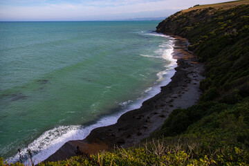 view from the cliff on orange sand beach coastal vegetation with marine wildlife sightings, located...