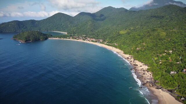 aerial view of a beach in Trindade district in Paraty during a sunny day, with few clouds and green forest