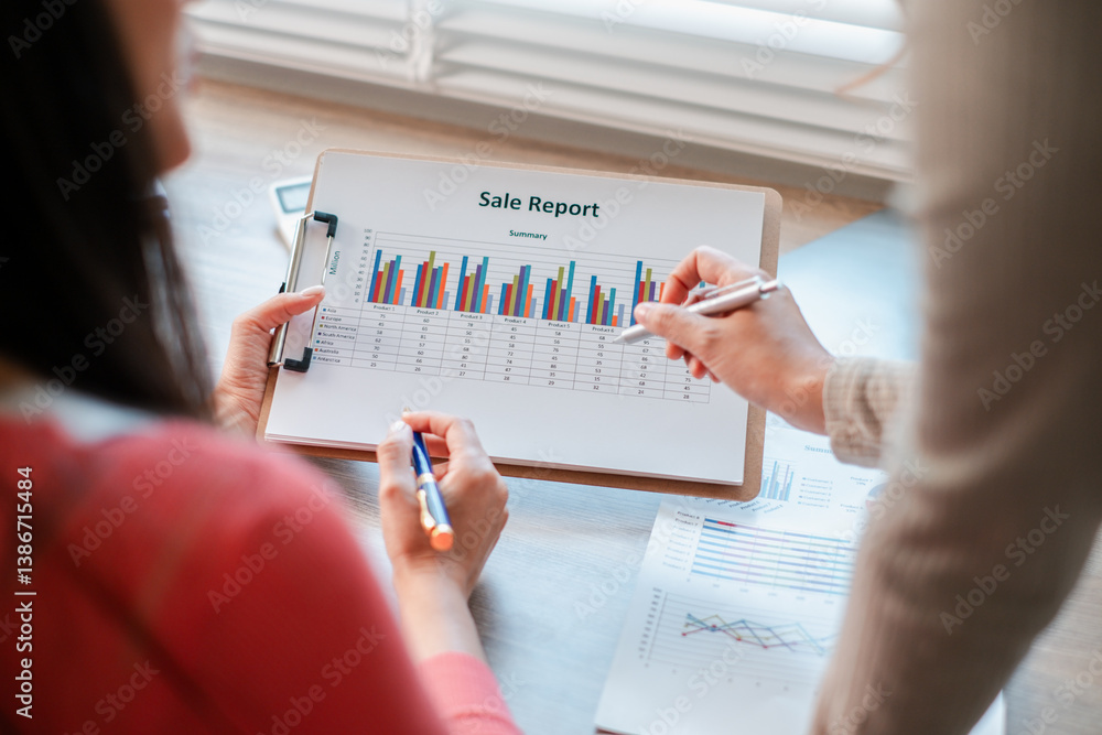Poster two professionals reviewing sales report data with charts and graphs, highlighting business analysis
