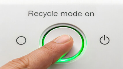 Fototapeta premium Conceptual image for World Environment Day. Finger pressing recycle mode button with glowing green light.