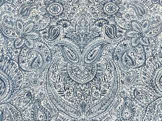 Ornamental blue paisley in flower and leaves pattern. Wallpaper, graphic background, or fabric in printed blue paisley and lace ornaments. Seamless background texture. Indonesian batik