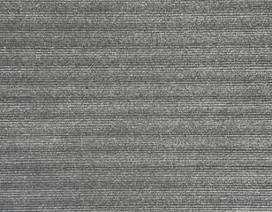Close up of stone tiles embossed with horizontal stripes in repeated pattern. Fluted horizontal grey stone tiles. Seamless background texture.