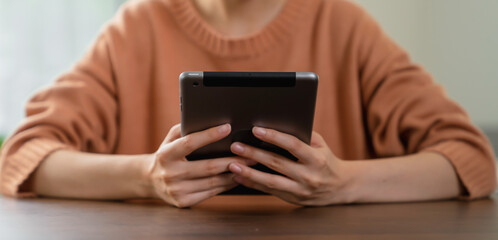 woman hand holding digital tablet and touching on screen.