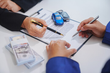 Man signing car insurance document or lease paper. Writing signature on contract or agreement....
