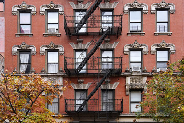 Old New York apartment building with ornate moldings front fire escape