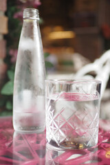 Refreshing water served with a glass on a cozy outdoor table