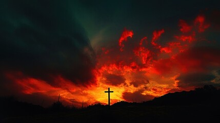 Obraz premium Fiery Sunset, Silhouette Cross: A Dramatic Landscape