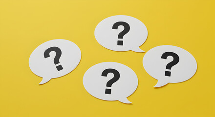 Four White Question Mark Speech Bubbles on a Bright Yellow Background Depicting Inquiry and Communication
