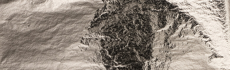 Silver and gray metallic foil texture with a chic, luxurious design. Pearlescent, reflective surface, perfect for a New Year or holiday card. Elegant panoramic backdrop with a bright, gradient effect