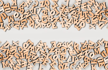Beautiful wooden letters of the English alphabet laid out from below and from above forming free...