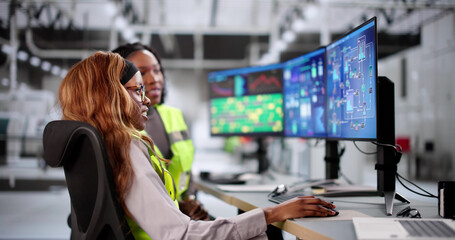 Female engineer operating SCADA system at industrial plant