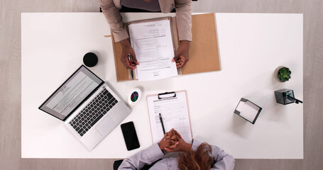 Top Law Office Recruiter Reviewing Young Professional's Resume