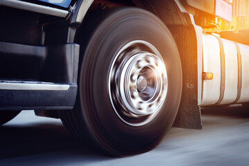 Motion of Semi Truck Driving on The Road. Fast Spinning Wheels on Road. Truck Wheels Tires. Big rig, Semi Trailer Truck Wheels. Freight Truck Logistics Transportation.	